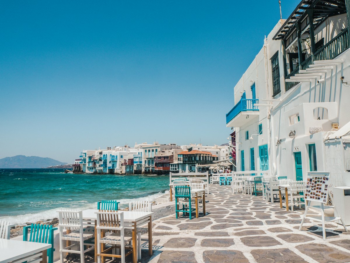 Santorini at sunset with white buildings and blue domes